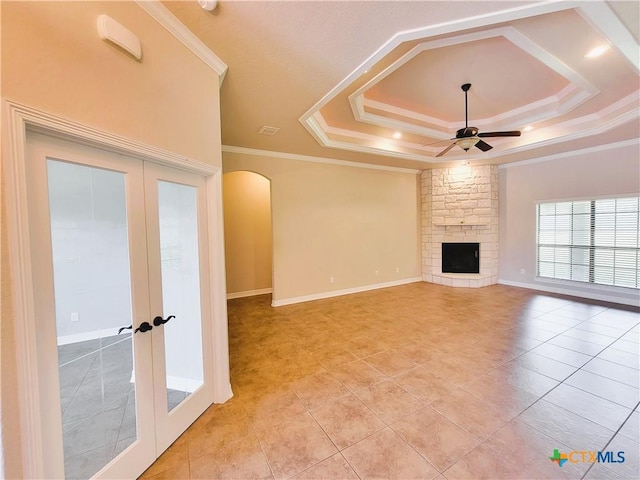 6409 Jovana Dr, Killeen, TX 76542 - unfurnished living room with french doors, ceiling fan, arched walkways, crown molding, and a tray ceiling