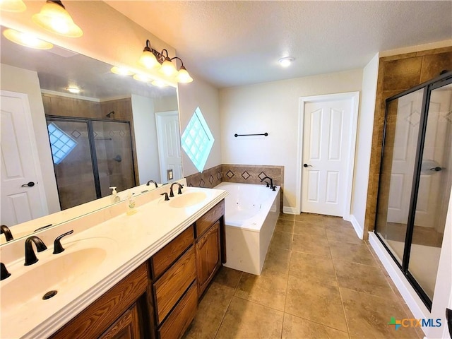 6409 Jovana Dr, Killeen, TX 76542 - bathroom featuring a garden tub, tile patterned flooring, a shower stall, double vanity, and a textured ceiling