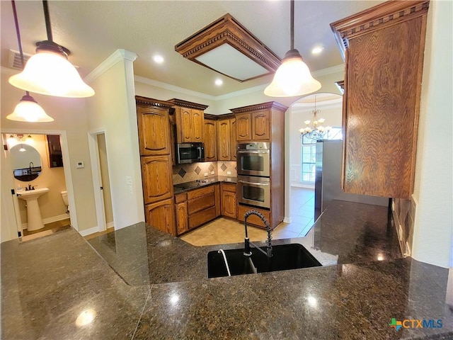 6409 Jovana Dr, Killeen, TX 76542 - kitchen featuring stainless steel appliances, crown molding, a chandelier, brown cabinets, and decorative backsplash