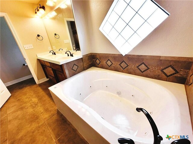 6409 Jovana Dr, Killeen, TX 76542 - bathroom with double vanity, a tub with jets, and tile patterned flooring
