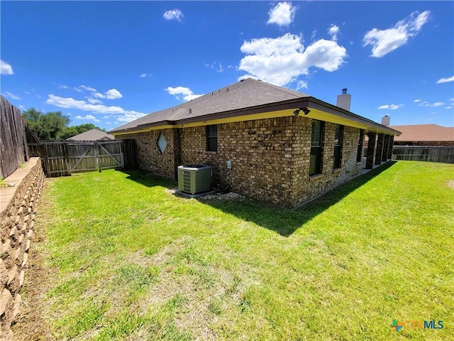 6409 Jovana Dr, Killeen, TX 76542 - rear view of house with a chimney, a fenced backyard, and brick siding