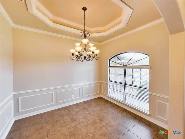 6409 Jovana Dr, Killeen, TX 76542 - tiled empty room with a raised ceiling, a chandelier, a decorative wall, crown molding, and a wainscoted wall
