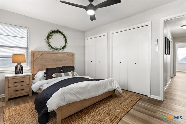 empty room with ceiling fan, wood-type flooring, and a healthy amount of sunlight