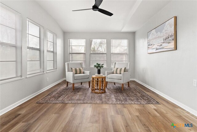 unfurnished bedroom with ceiling fan, wood-type flooring, and two closets