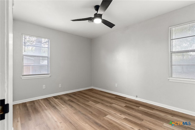 spare room featuring hardwood / wood-style floors and ceiling fan