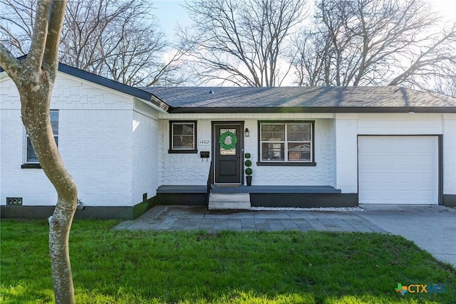 ranch-style home with a garage, a front lawn, and a porch