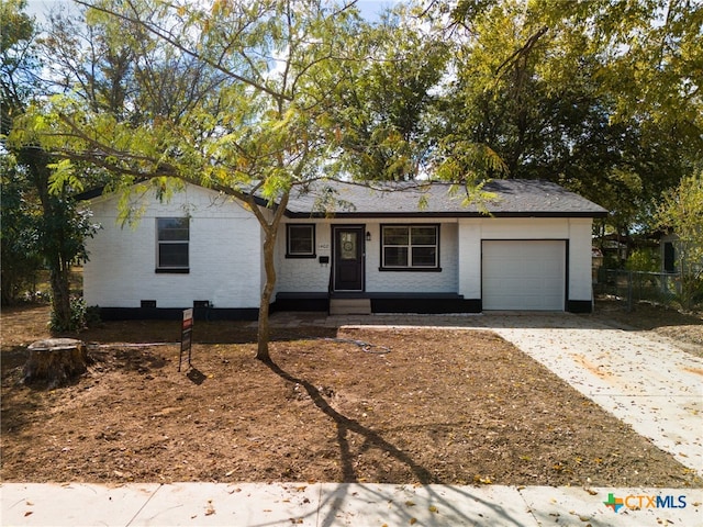 ranch-style house featuring a garage