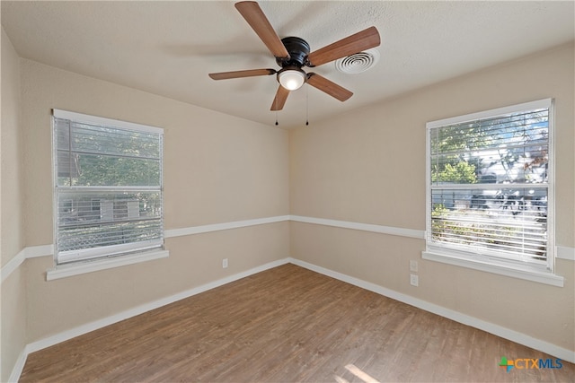 spare room featuring hardwood / wood-style flooring and ceiling fan