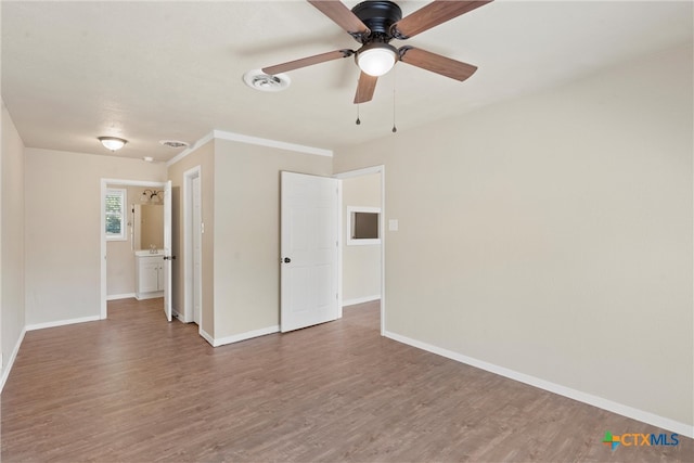 spare room featuring dark hardwood / wood-style flooring and ceiling fan