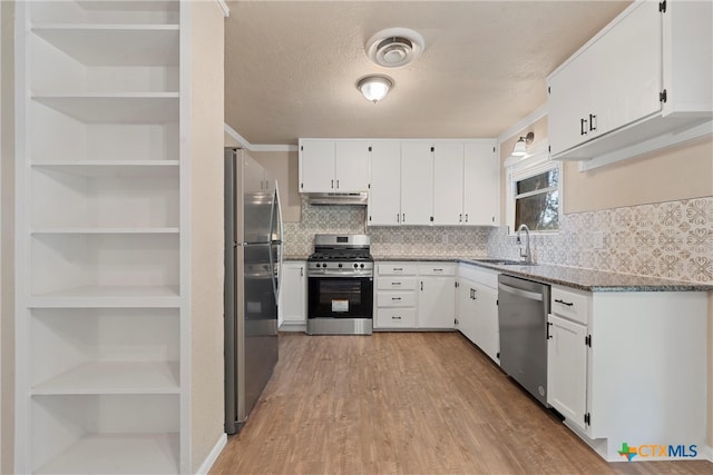 kitchen featuring stainless steel appliances, white cabinets, sink, and light hardwood / wood-style flooring