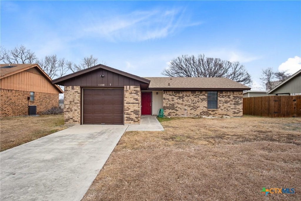 ranch-style home with a garage and a front yard