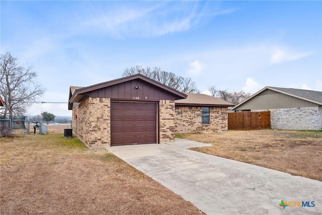 ranch-style home featuring a garage and a front lawn