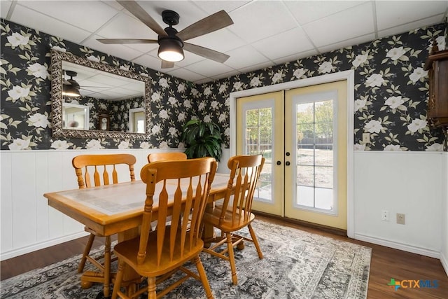1322 Rivercrest Dr, New Braunfels, TX 78130 - dining room featuring wallpapered walls, wood finished floors, french doors, wainscoting, and a drop ceiling