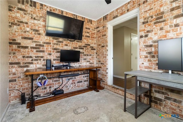 1322 Rivercrest Dr, New Braunfels, TX 78130 - living room with an office area, baseboards, unfinished concrete flooring, and brick wall