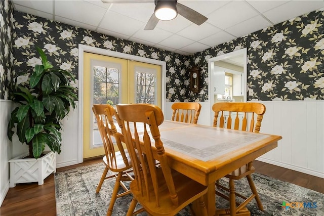 1322 Rivercrest Dr, New Braunfels, TX 78130 - dining area with wallpapered walls, wainscoting, wood finished floors, a paneled ceiling, and a ceiling fan
