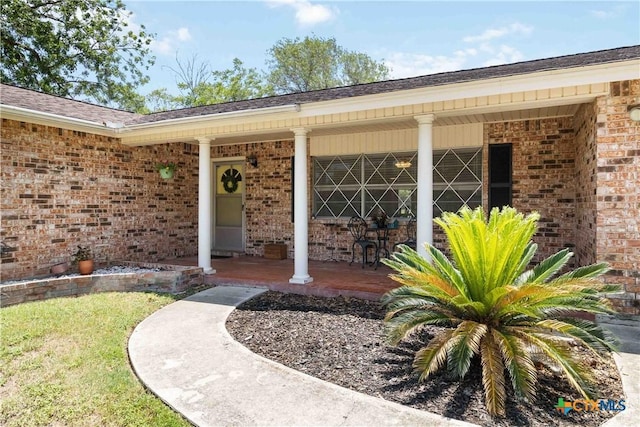 1322 Rivercrest Dr, New Braunfels, TX 78130 - entrance to property with a porch, brick siding, and a shingled roof