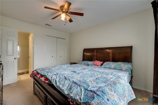 bedroom with visible vents, light carpet, a textured ceiling, and a closet