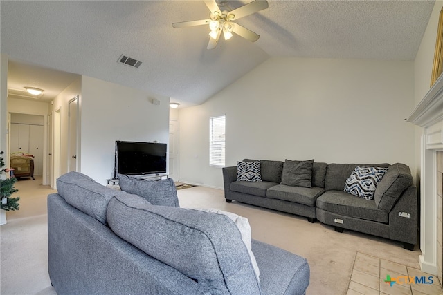 living area featuring visible vents, a textured ceiling, lofted ceiling, light colored carpet, and ceiling fan