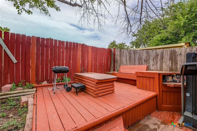 wooden deck featuring a fenced backyard