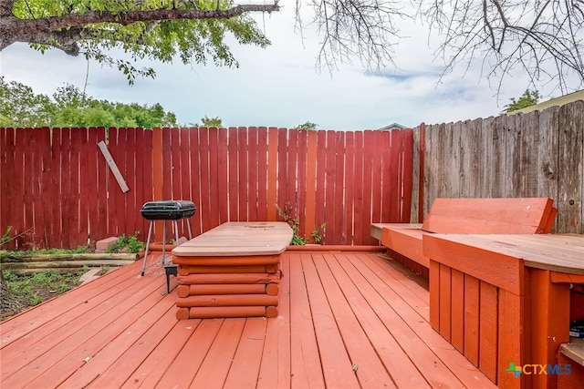 wooden deck featuring a fenced backyard