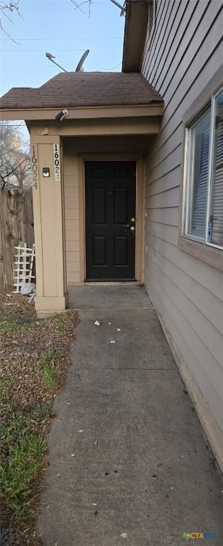 view of exterior entry with fence