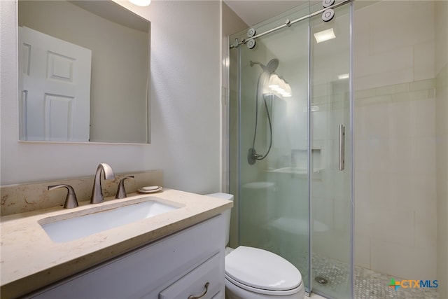 full bathroom with vanity, toilet, and a shower stall