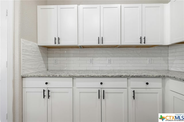 interior details featuring decorative backsplash