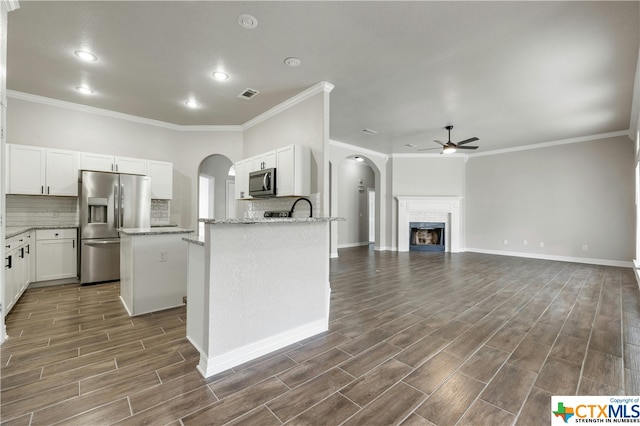 kitchen with white cabinetry, stainless steel appliances, dark hardwood / wood-style floors, and a center island