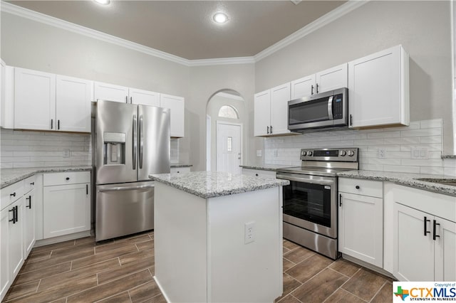 kitchen with white cabinetry, light stone counters, and stainless steel appliances