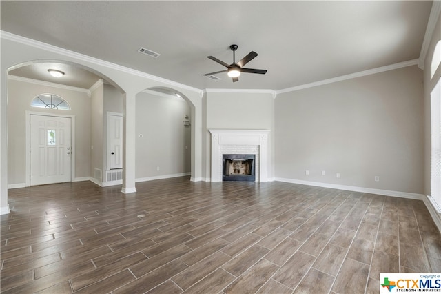 unfurnished living room featuring ornamental molding, dark wood-type flooring, and ceiling fan