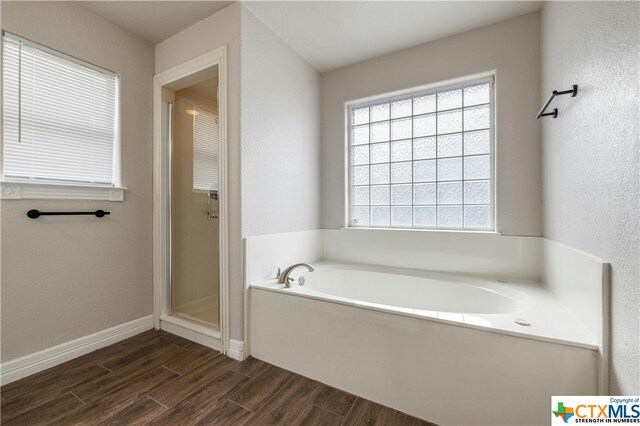 bathroom featuring hardwood / wood-style floors and shower with separate bathtub