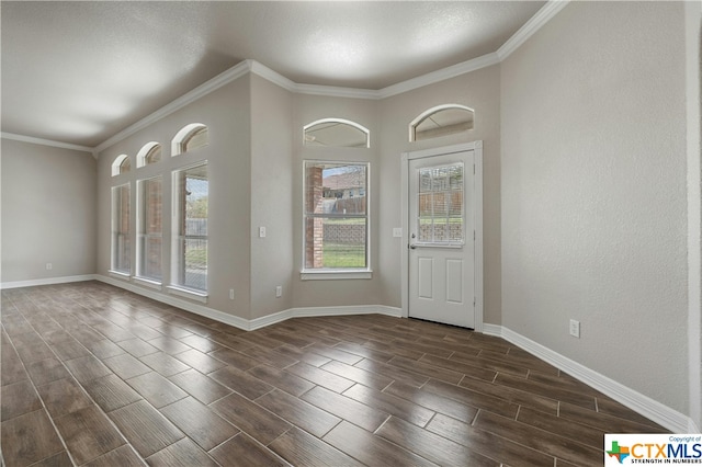 foyer entrance with dark wood-type flooring and crown molding