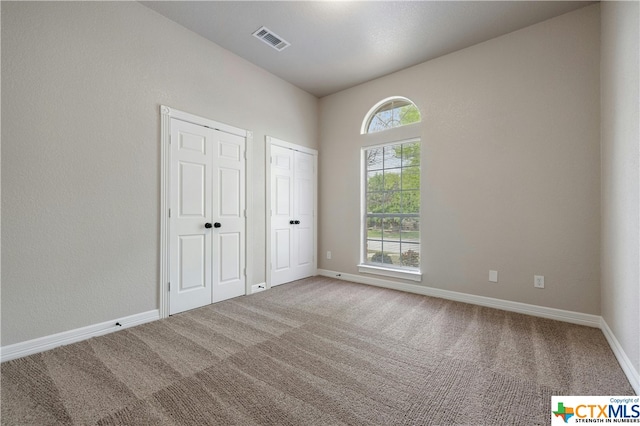 unfurnished bedroom with carpet flooring