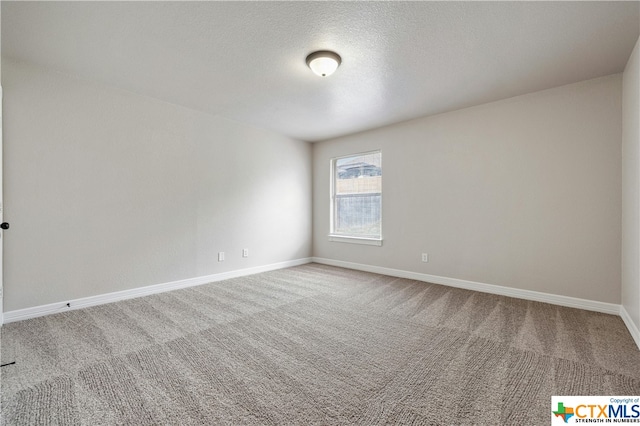 empty room featuring a textured ceiling and carpet floors