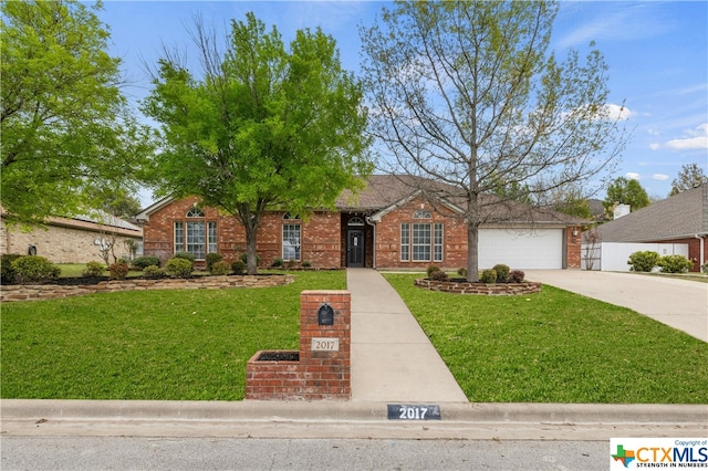 ranch-style house featuring a front lawn and a garage