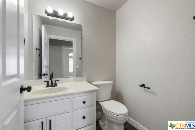 bathroom featuring toilet and vanity