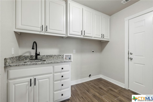 washroom featuring hookup for an electric dryer, washer hookup, dark hardwood / wood-style flooring, cabinets, and sink