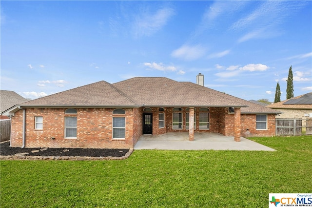 rear view of house featuring a lawn and a patio area