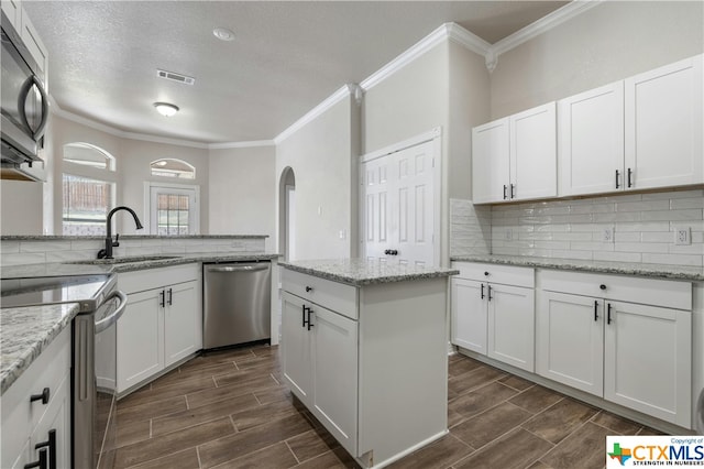 kitchen featuring white cabinetry, appliances with stainless steel finishes, a textured ceiling, and sink