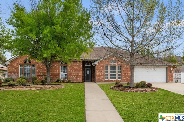 ranch-style house with a garage and a front lawn