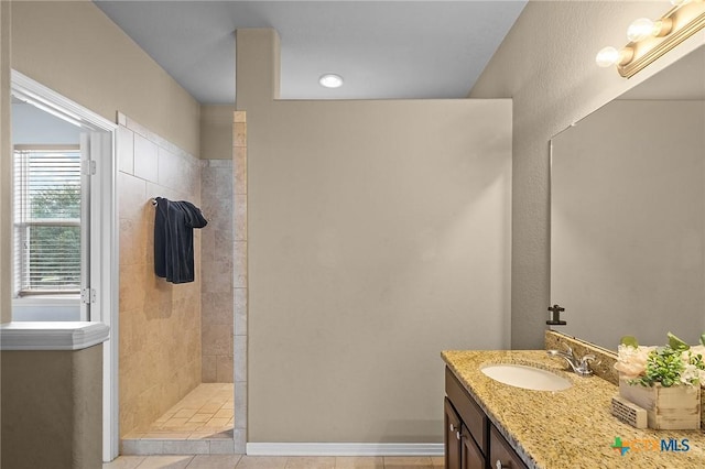 125 Flint Rock Ct, Victoria, TX 77904 - full bath featuring vanity, a walk in shower, tile patterned flooring, and baseboards