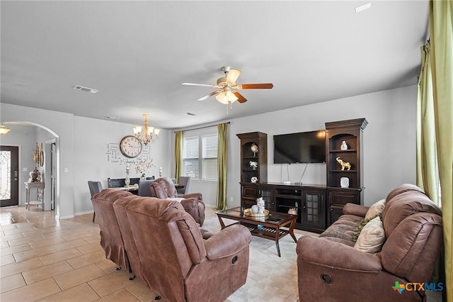 125 Flint Rock Ct, Victoria, TX 77904 - living room featuring arched walkways, a ceiling fan, a chandelier, light tile patterned floors, and baseboards