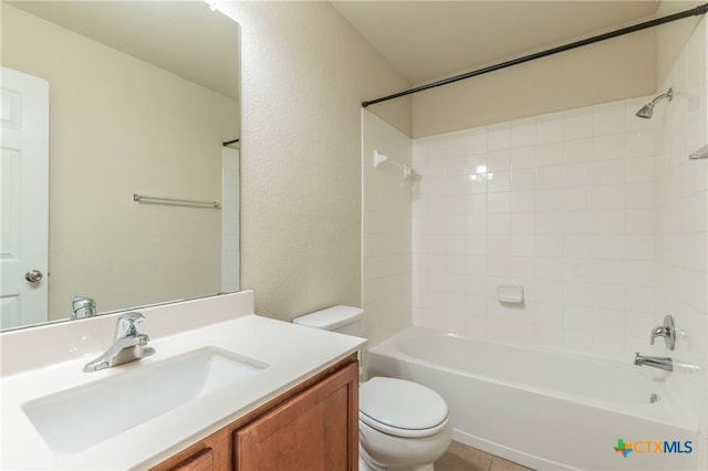 full bathroom with vanity, tiled shower / bath, and toilet