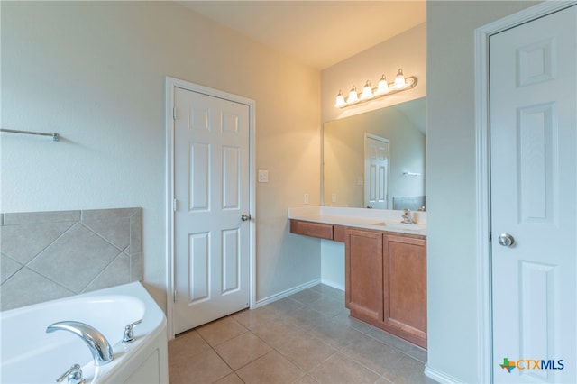 bathroom with vanity, tile patterned flooring, and a bathing tub