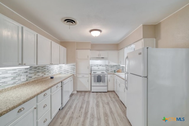 kitchen with tasteful backsplash, white cabinetry, and white appliances