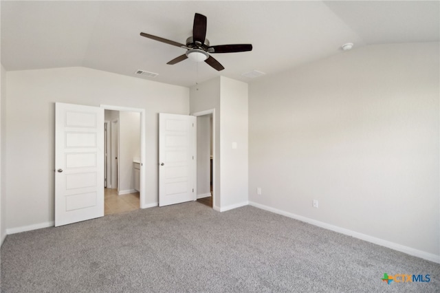 unfurnished bedroom with ceiling fan, light colored carpet, and vaulted ceiling