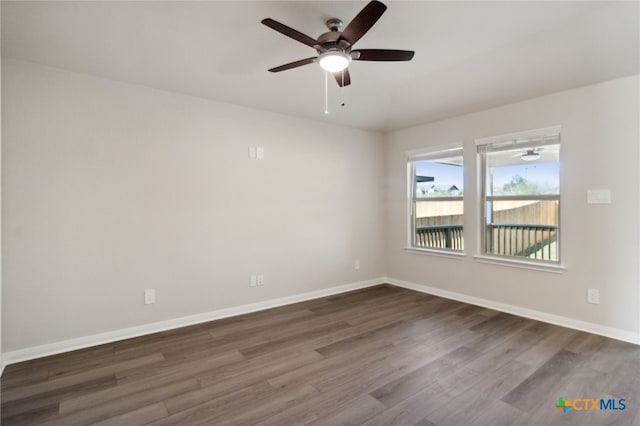 unfurnished room with dark hardwood / wood-style floors and ceiling fan