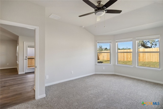 unfurnished room with ceiling fan, dark hardwood / wood-style floors, and lofted ceiling