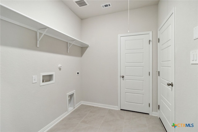 clothes washing area with hookup for an electric dryer, light tile patterned flooring, gas dryer hookup, and hookup for a washing machine