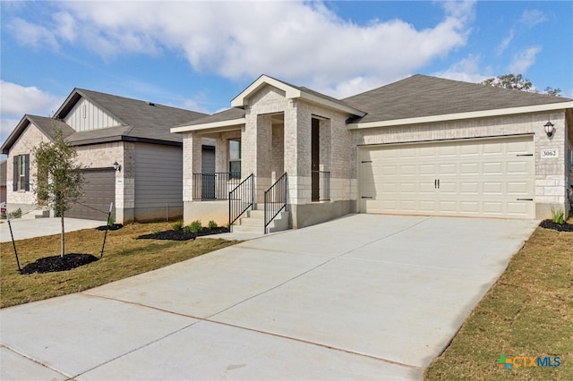 ranch-style home with a porch, a front yard, and a garage